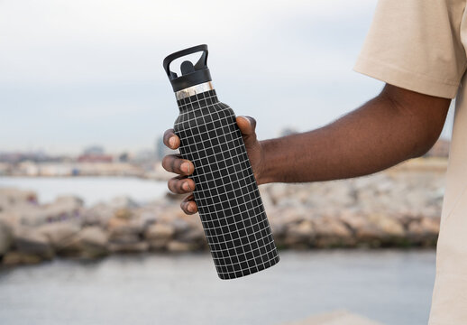 Mockup of man holding customized water bottle