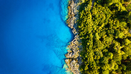 Drone view of the sea coast. Rocky shore and sea water. Vacation and travel. Summer seascape. aerial view. Image for cards, background, wallpaper or design.