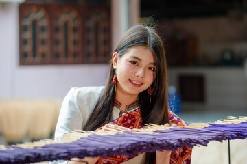 teenage girl dressed in traditional Thai clothing