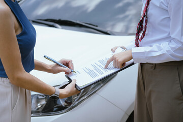 Insurance concept, insurance agent checking broken car and submit a claim form after an accident traffic accident.