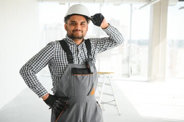 Indian worker makes repairs in an apartment