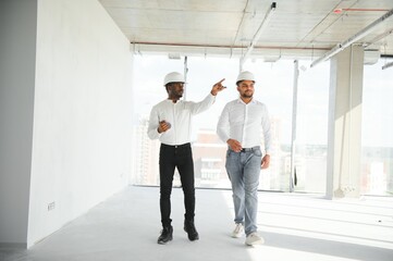 engineers team are discussing while inspecting at construction site