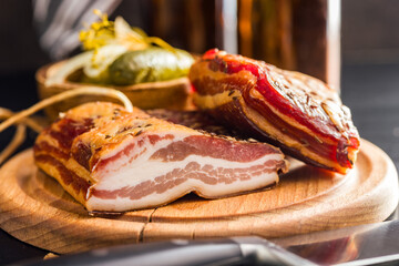 Closeup of Sliced Smoked Bacon on wooden Cutting Board.