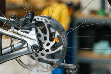 Detail shot of the disc brake of a mountain bike spinning.