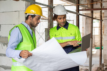 man engineer builder house construction holding blueprint drawing. male architect standing at home construction. foreman in workplace.