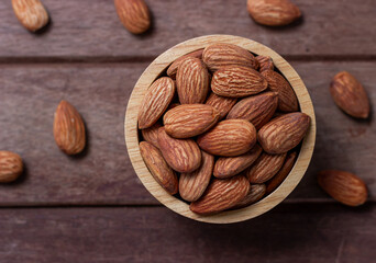 Almond snack fruit in wooden bowl blurred background