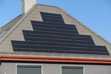 High-tech solar roof tiles on roof as solar power plant. Solar shingles installed on roof of...