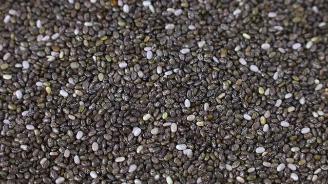 Gray chia seeds circle rotation close up top view