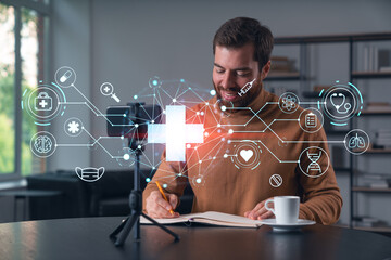 Happy man is making video blog using smartphone on a tripod explaining, teaching, master class people in room. Concept of online stream, business education, conference call. Healthcare seminar