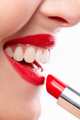 Naklejka premium Woman, apply and lips for lipstick in studio, makeup and cosmetics for care on white background. Female person, red and skincare or silver tube, grooming and application of gloss or skin treatment