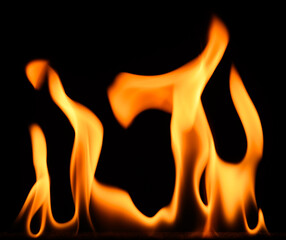 fire on a black background, burning and hot flames, close view