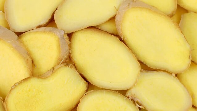 Fresh cut ginger root slices circle rotation close up