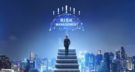 Businessman climbed stairs, risk management hologram and business skyline