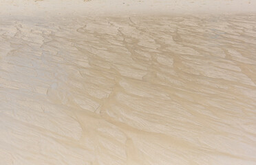 White sand on the seashore as an abstract background. Texture