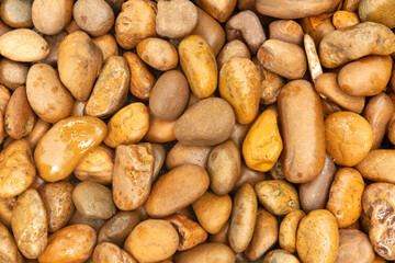 Round stones in the wall as an abstract background. Texture