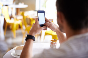 Man, hands and typing with phone at restaurant in social media, communication or networking at cafe. Closeup of male person on mobile smartphone for online chatting, texting or message at coffee shop
