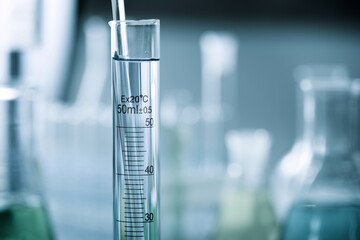 Laboratory glassware placed in a  table with liquid sample