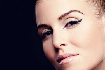 Woman, glow and portrait in studio for beauty, foundation and makeup treatment on black background. Female person, dermatology and confidence for shine, mockup space and facial wellness for cosmetics