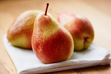Home, fruits or healthy pears in kitchen for fiber, organic or balanced diet for nutrition, meal or snacks. Background, vegan or closeup of natural ingredients for vitamins, fresh produce or raw food