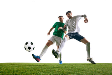 Player in white extends his leg to intercept player in green's kick on green lash playground against white background. Concept of professional sport, championship, final match, movement. Ad
