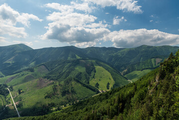 Obraz premium Vratna valley with hills of Mala Fatra mountains above from Zbojnicky chodnik hiking trail bellow Male noclahy signpost
