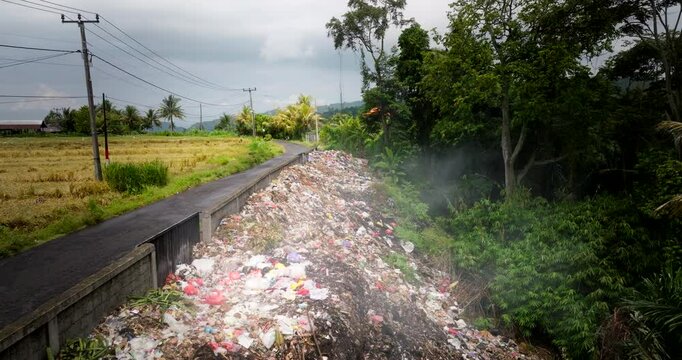 Disgusting environmental damage as human garbage is disposed on roadside Bali