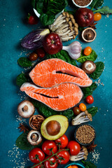 Top view, vertical photo. Healthy food clean eating selection. Superfood, fish and fruit.