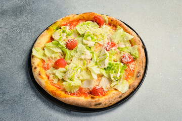 Pizza Caesar. Pizza with chicken, cheese and lettuce. Top view. Free space for your text.