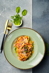 Homemade bolognese pasta. In a plate. Top view. Vertical photo.