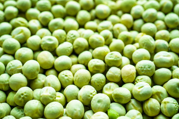 Background of a green peas grains close up. Food pattern.