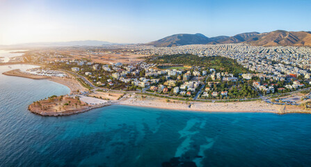 Aerial view of the coastline of Glyfada, south Athens, Greece, with beaches and marinas during summer sunset time