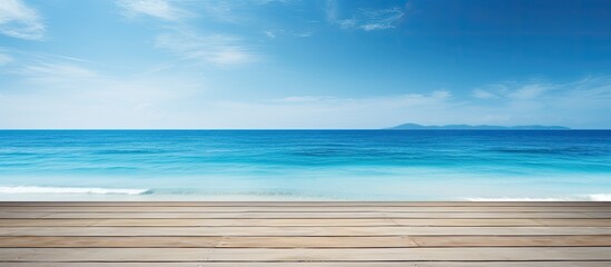 Fototapeta premium A scenic summer tropical sea with a spacious wooden table set against a clear blue sunny sky A versatile background template allowing ample space for your product