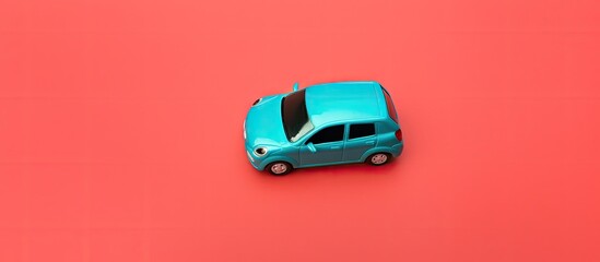 Top view of a toy car placed on a blue background with the words car sharing creating a copy space image to represent the carsharing concept