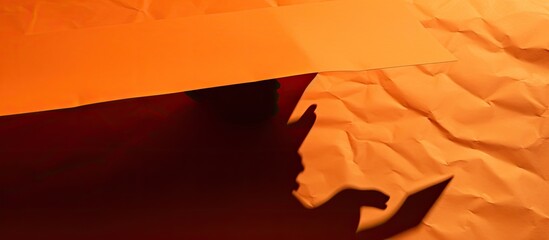 A psychology concept of shadow work symbolized on a beautiful white paper with a copy space image against a background of stunning orange paper
