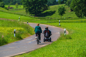 Fototapeta premium Family with different life generations on the road and enough their time at green landscape