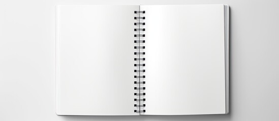 Top view of a blank spiral sketchbook with an empty open page captured in a real photo The white background allows for text placement and there is ample copy space This black and white panoramic mini