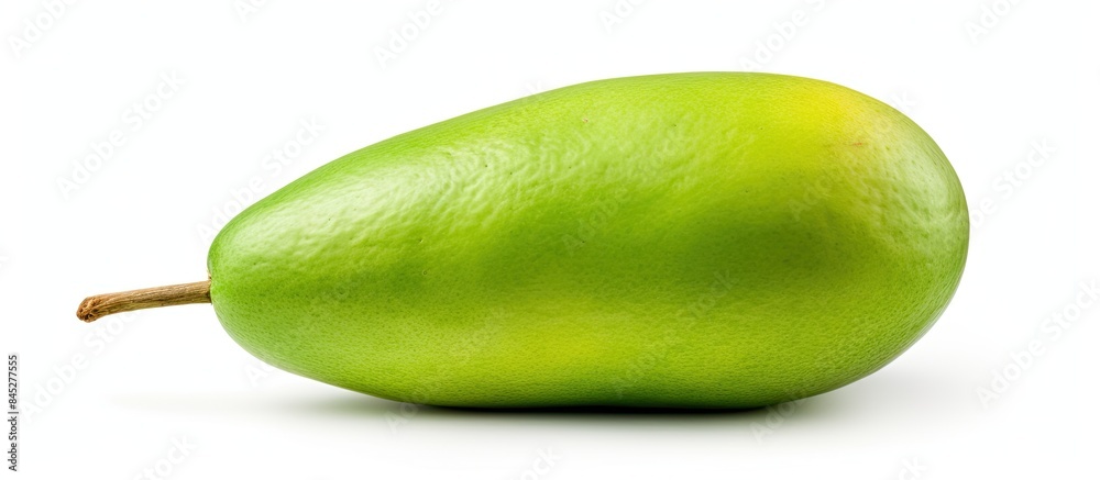 Poster A single raw green mango with its stem is captured in a close up view The mango symbolizing natural tropical food is isolated on a white background This image is perfect for food related concepts wit