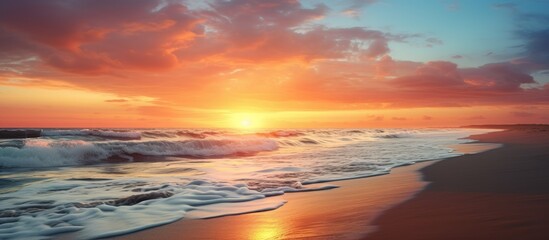 Fototapeta premium Beautiful sunset at the beach with a mesmerizing view of the sun disappearing into the horizon creating a serene ambiance Perfect for a copy space image