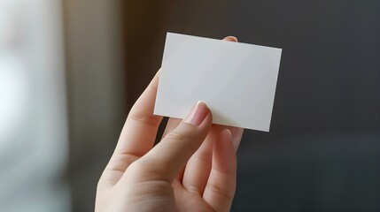 Obraz premium Female hand holding a business card mockup