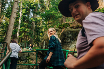 Happy man and woman hiking in forest
