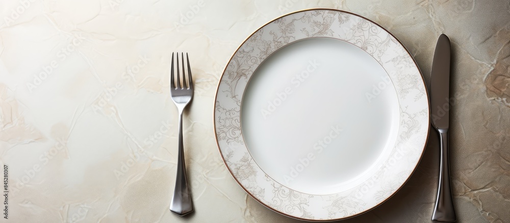 Poster a white dinner plate sits on a white marble surface featuring intricate patterns a shiny silver spoo