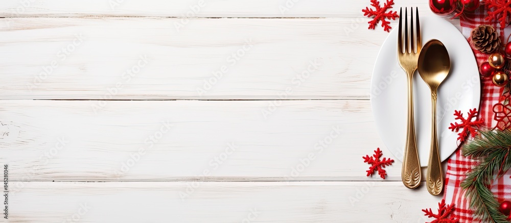 Poster a festive christmas holiday background featuring a red napkin and elegant cutlery arranged on a whit