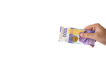 One 1000 Swiss francs cash banknote or bill held by Caucasian male hand. Close up studio shot, white background