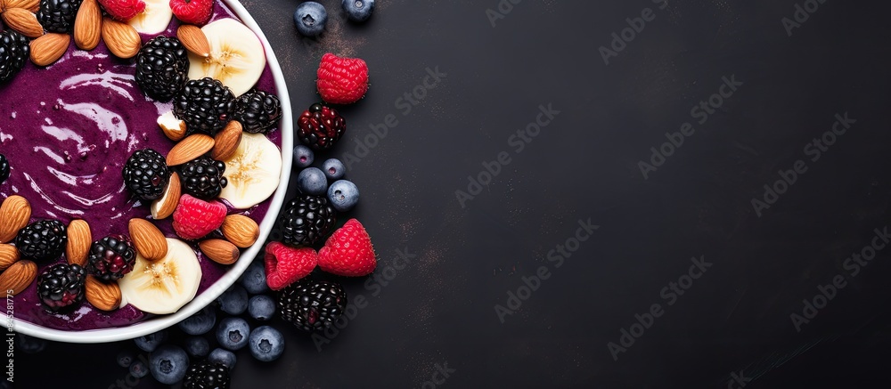 Poster a healthy dessert of mashed berries banana and natural yogurt in a white bowl adorned with frozen bl
