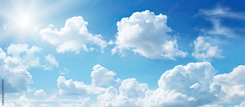 Poster a sunny day with a beautiful clear blue sky and white clouds creates a bright and vibrant nature bac