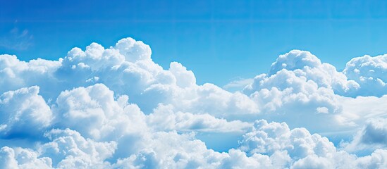 Copy space image of a serene blue sky adorned with exquisite white clouds boasting a captivating color transition from vibrant blue to a gentle fade forming a picturesque cloudscape