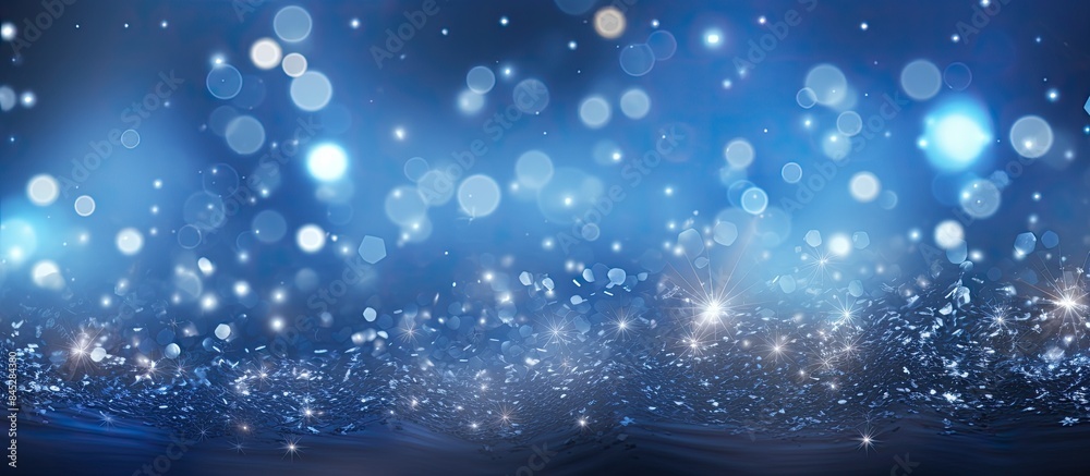 Leinwandbilder a magical blue bokeh with blinking stars and falling snowflakes creates an abstract christmas backgr