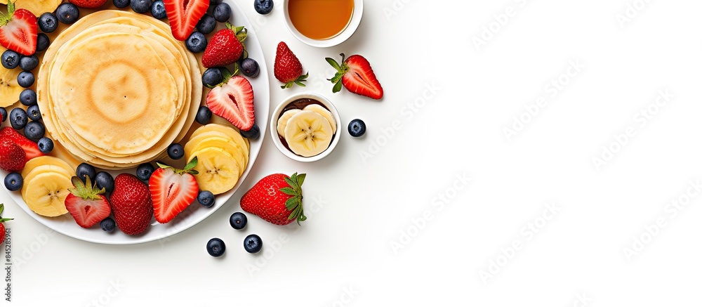 Poster top view of a summer breakfast consisting of delicious pancakes adorned with fresh fruits like banan