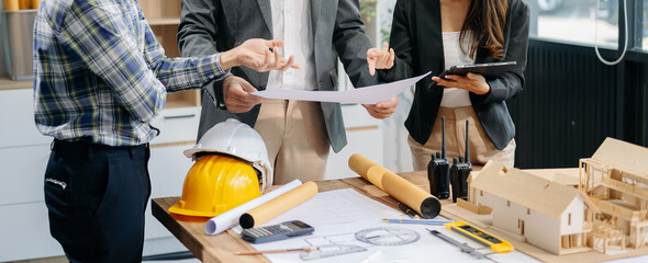 Engineer teams meeting working together wear worker helmets hardhat with on architectural project...