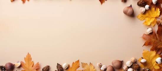 Fall themed flat lay composition with a border of dried oak leaves and acorns on an autumn background Ideal for Thanksgiving day or seasonal concepts with ample copy space for additional design eleme